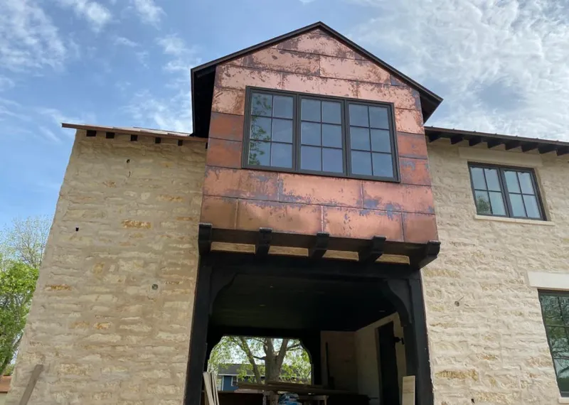 Copper metal panel facade on a stone building for Skylight Installation in Suncrest