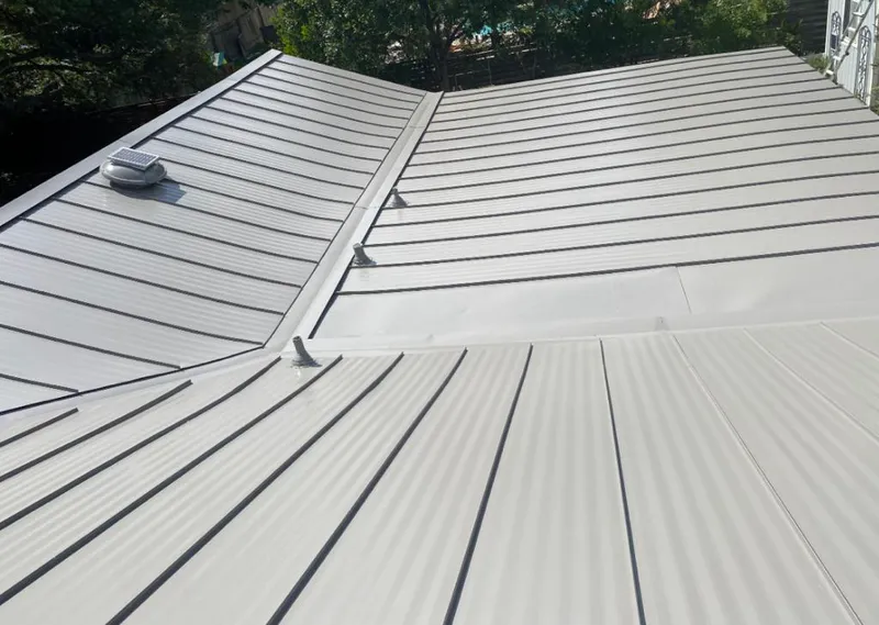 Solar attic fan installed on a metal roof for Roof Ventilation in Suncrest
